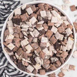 Cookies and cream muddy buddies in a white bowl.