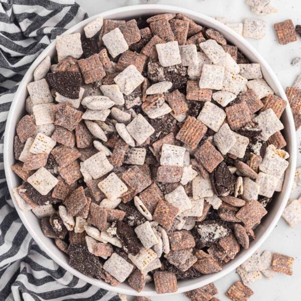 Cookies and cream muddy buddies in a white bowl.