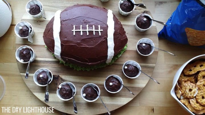 Football cake on a wooden platter.