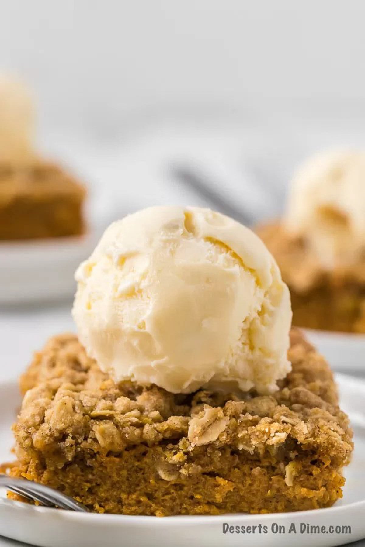 Pumpkin crisp topped with a scoop of vanilla ice cream