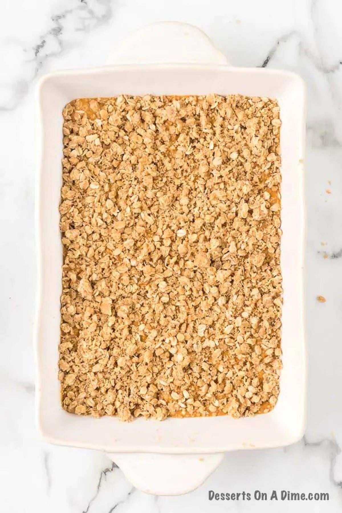 Oat topping sprinkled on top of pumpkin layer. 