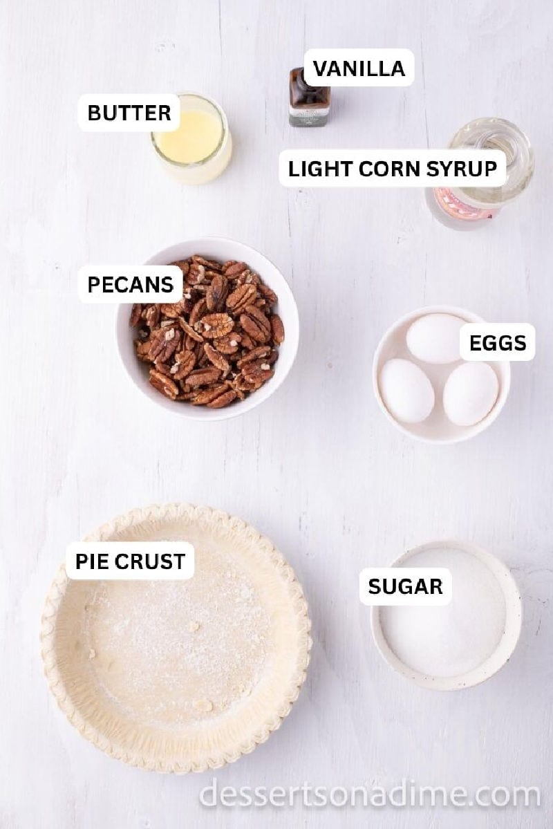 Ingredients for recipe: sugar, pie crust, eggs, pecans, corn syrup, vanilla and butter. 