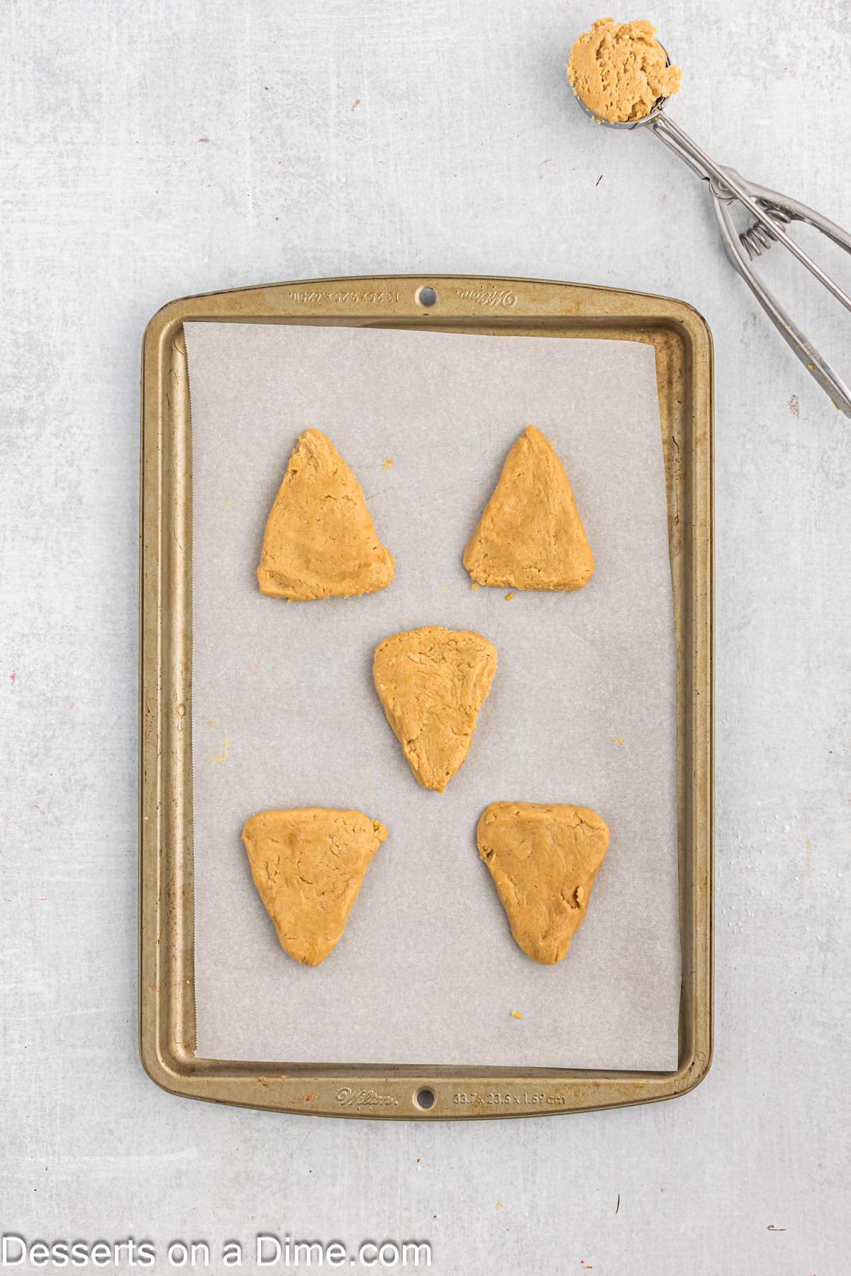 Baking sheet with cookies formed into triangles. 