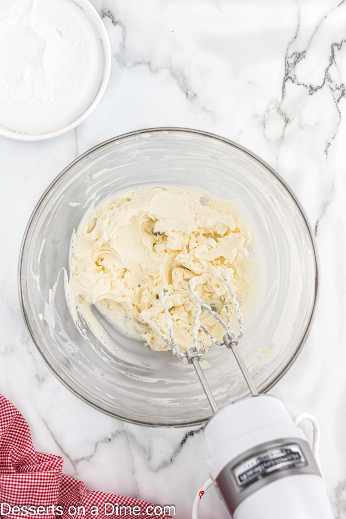 Filling in mixing bowl with an electric mixer. 