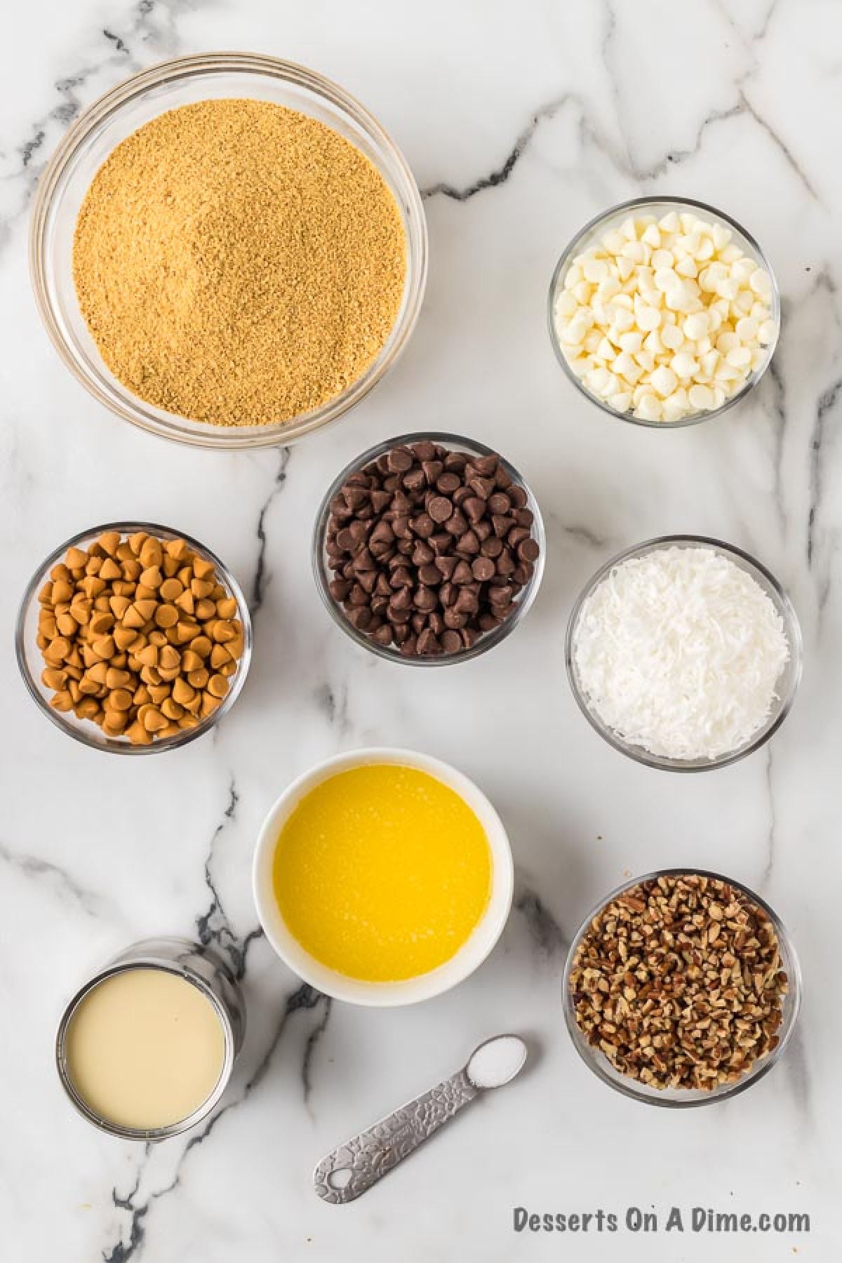 Ingredients for recipe: graham cracker crust, chocolate chips, butter, sweetened condensed milk, nuts, coconut. 