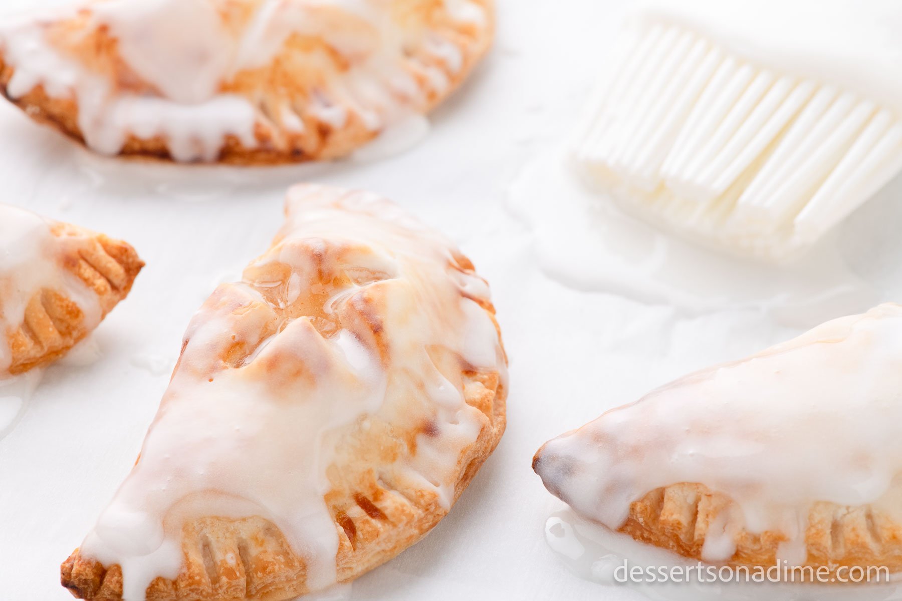 Air Fryer hand pies topped with glaze. 