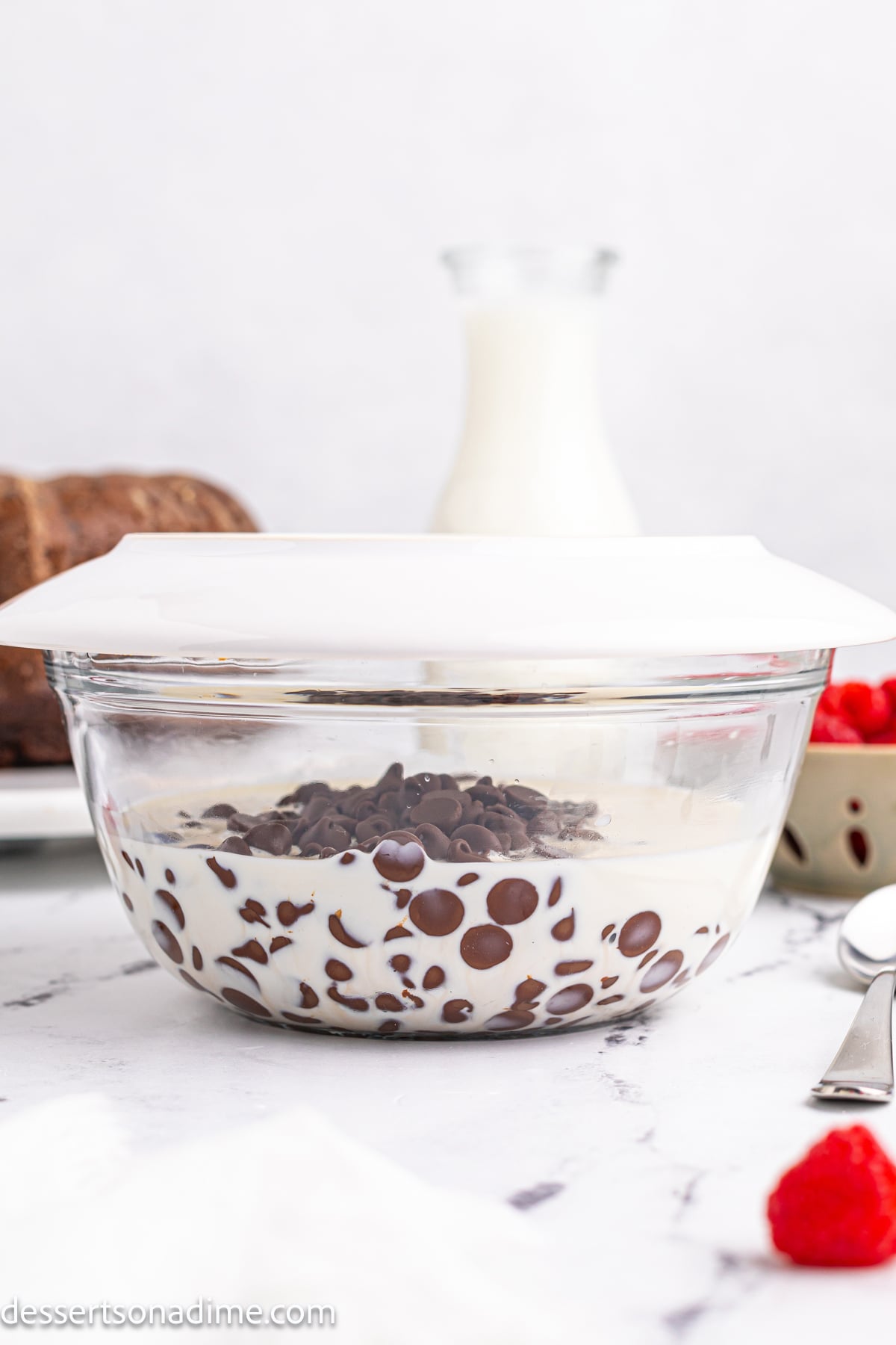 Mixing bowl with chocolate chips and heavy cream.