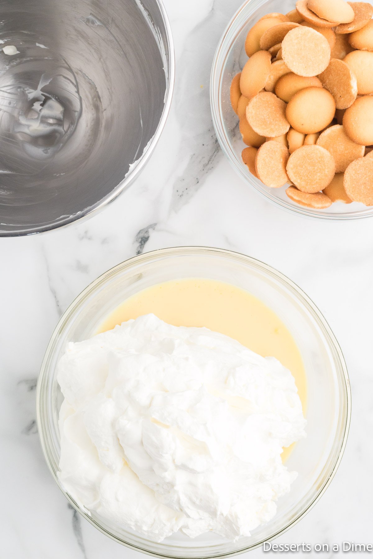 Bowl with whipped cream added to pudding.