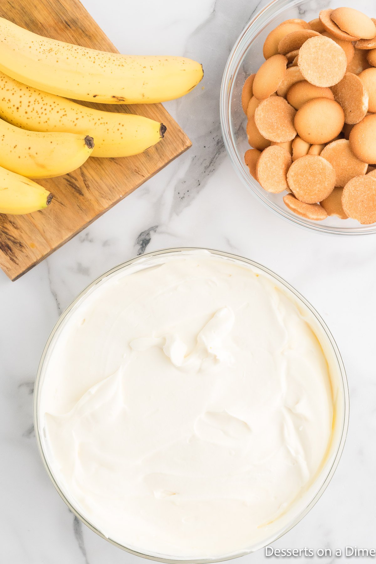 Pudding layered in dish and topped with whipped cream.