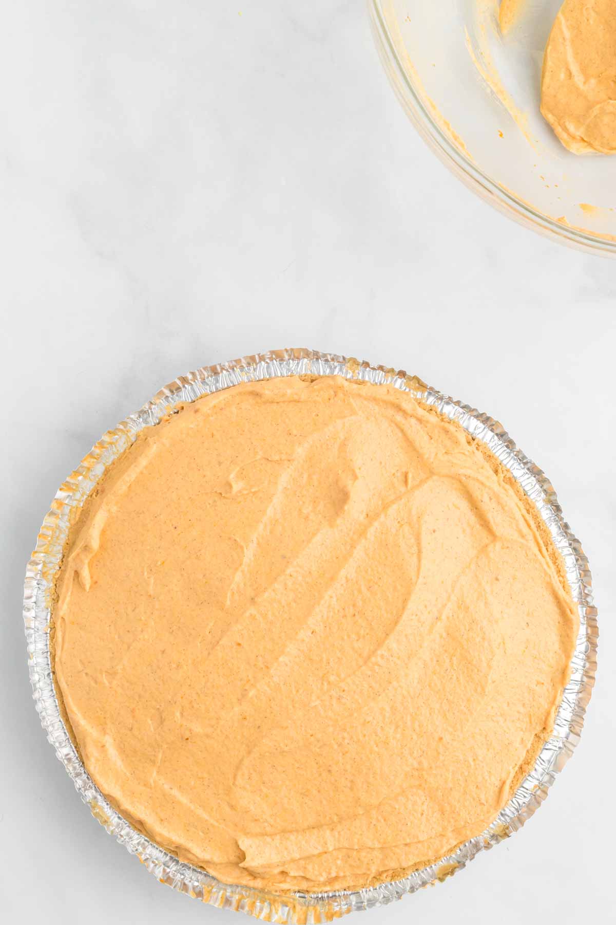 Pumpkin mixture combined together and spread in pie crust.