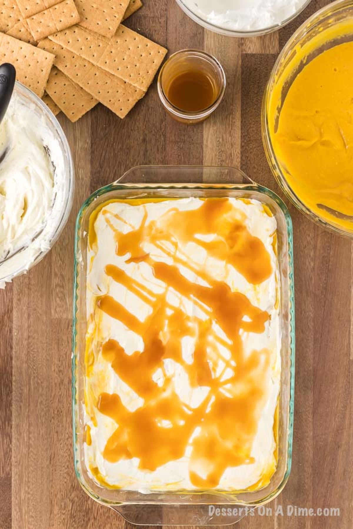 Caramel drizzled on top of the cream cheese layer of the pumpkin lasagna. 