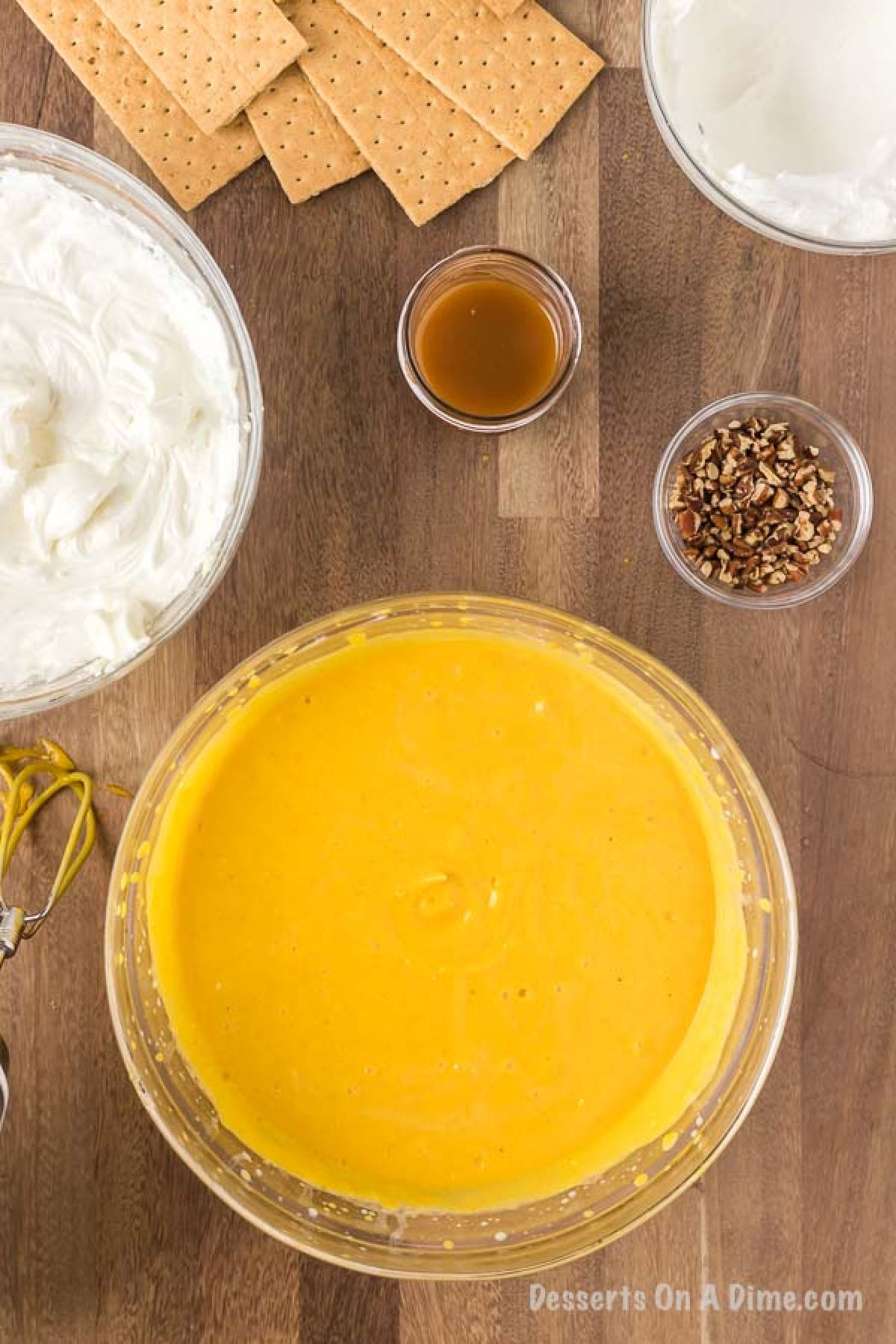 The Pumpkin puree, milk and pumpkin pie spice mixed together in a large mixing bowl.  