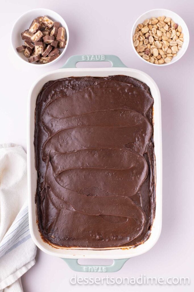 Chocolate frosting spread on cake.