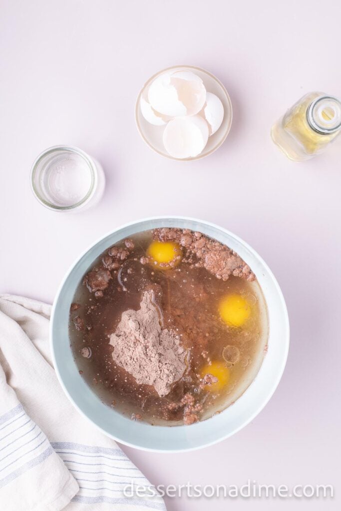 Mixing bowl with cake mix, oil, eggs being combined.