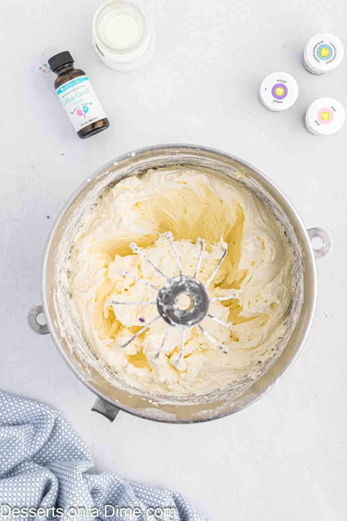 Frosting mixture combined together in a mixing bowl. 