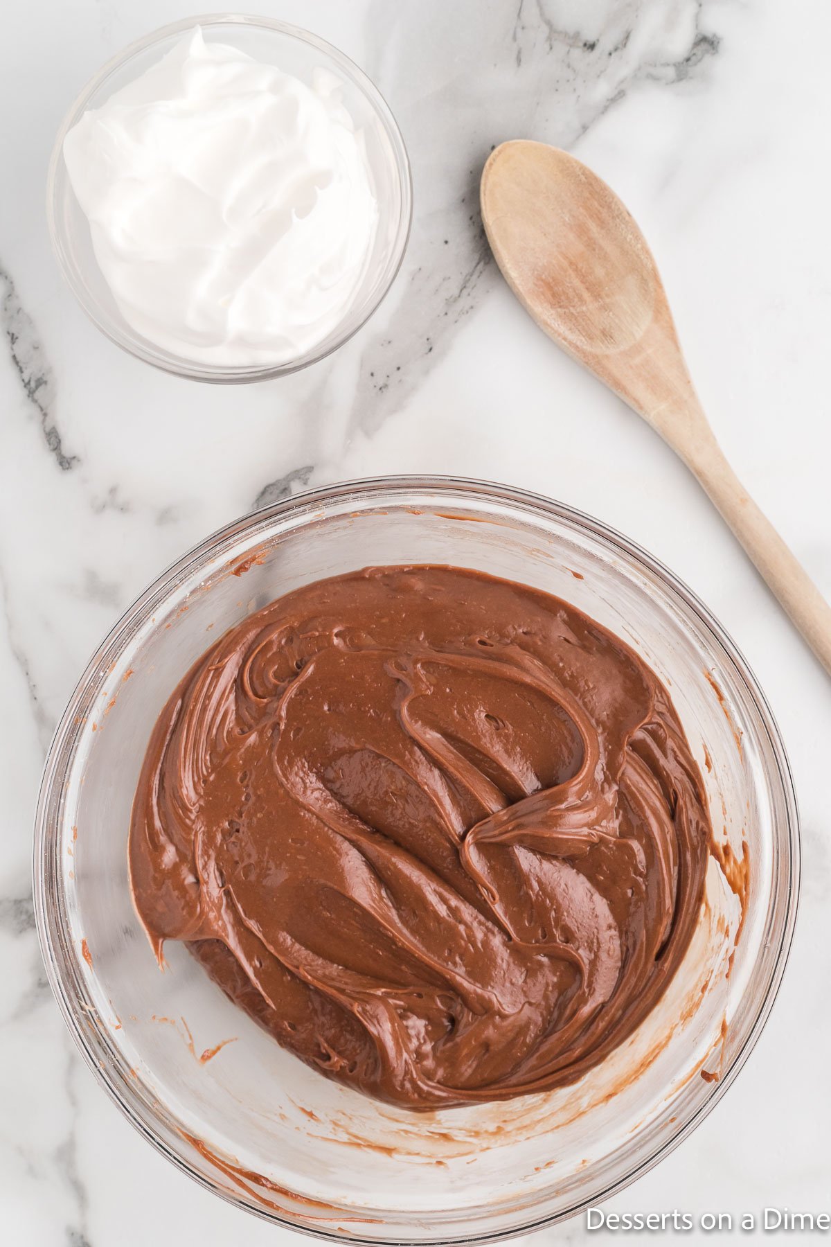 Nutella added to bowl with powdered sugar.
