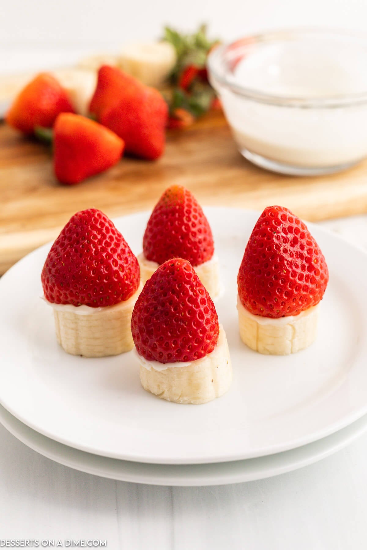 Strawberries on top of bananas. 