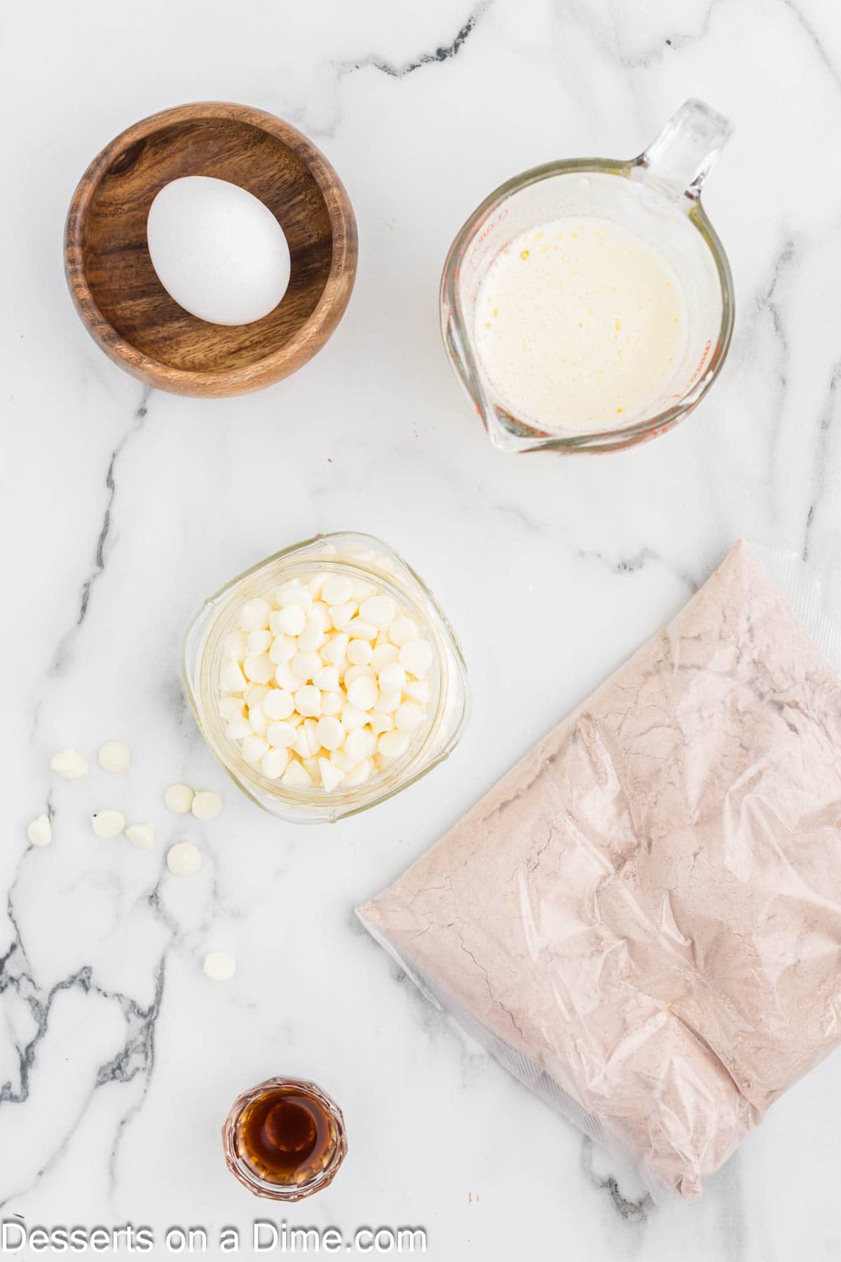 Ingredients for red velvet brownies - red velvet cake mix, egg, butter, vanilla, white chocolate chips. 
