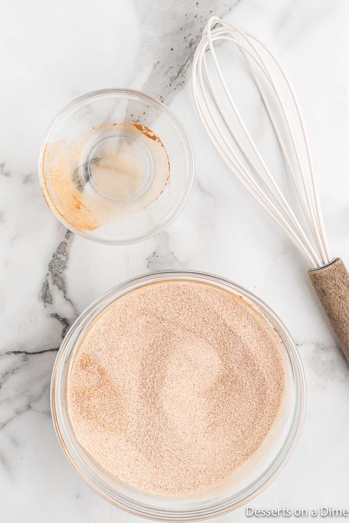 Apples in bowl with cinnamon and sugar. 