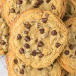 Crumble Chocolate chip cookies stacked together .