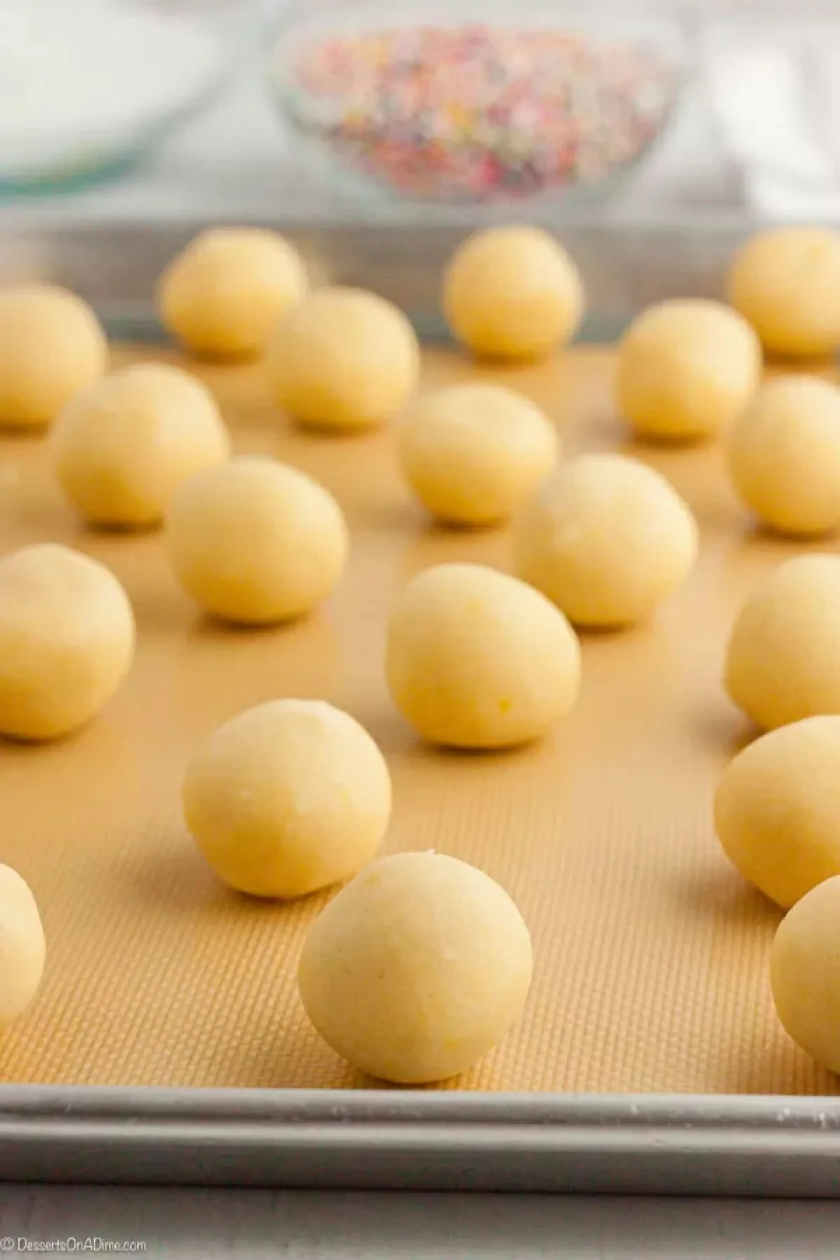 Cookie dough balls on baking sheet. 