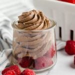 Keto Chocolate mousse in a glass with raspberries.