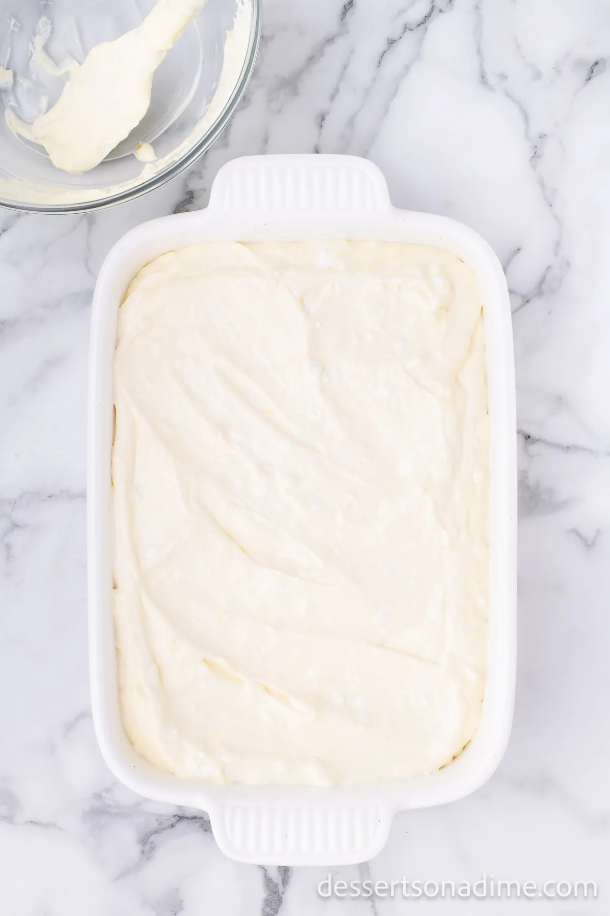 Cream cheese mixture spread on top of dish.