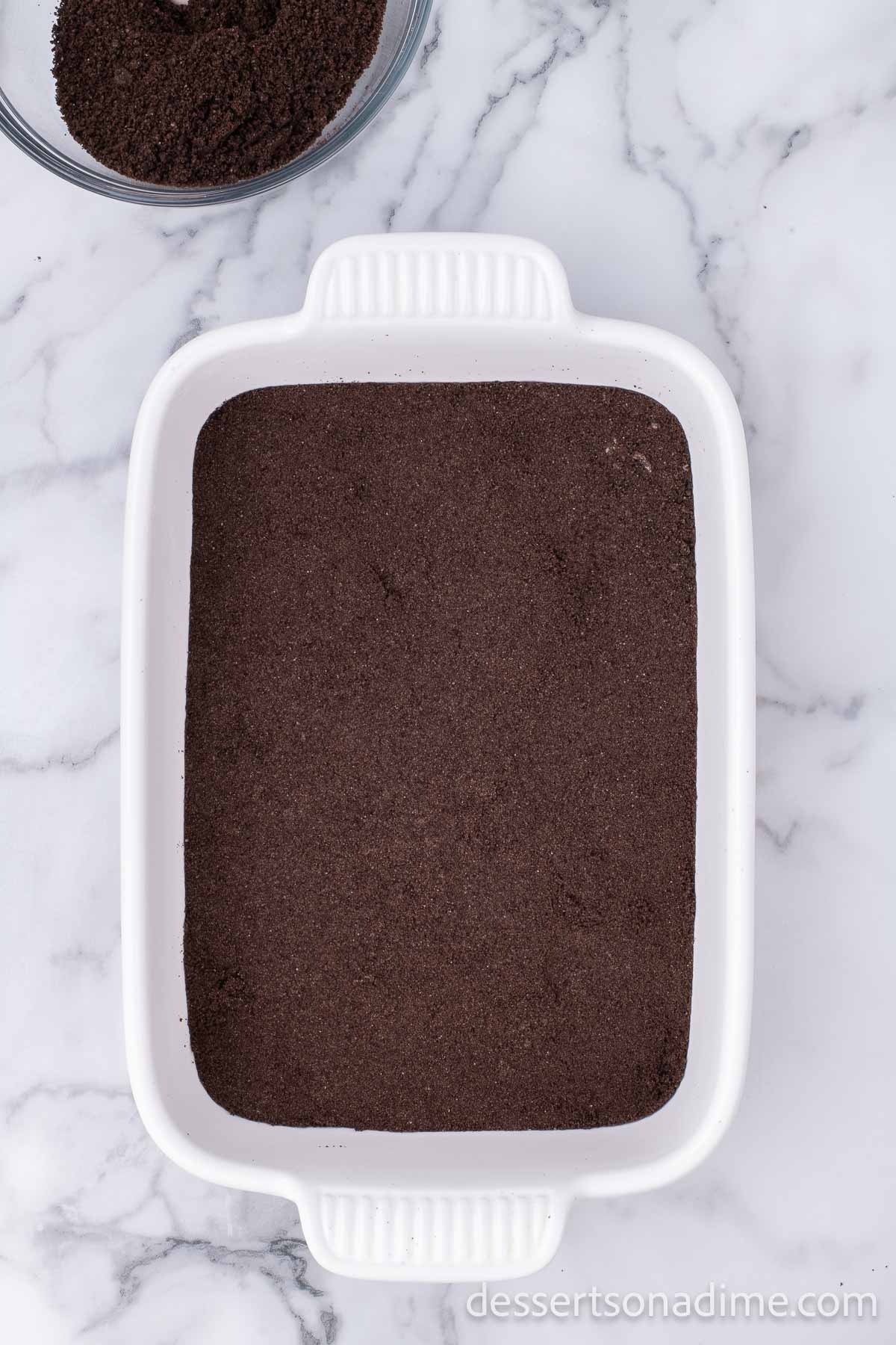 Crushed cookies in baking dish.