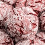 A pile of red velvet cookies with powdered sugar.