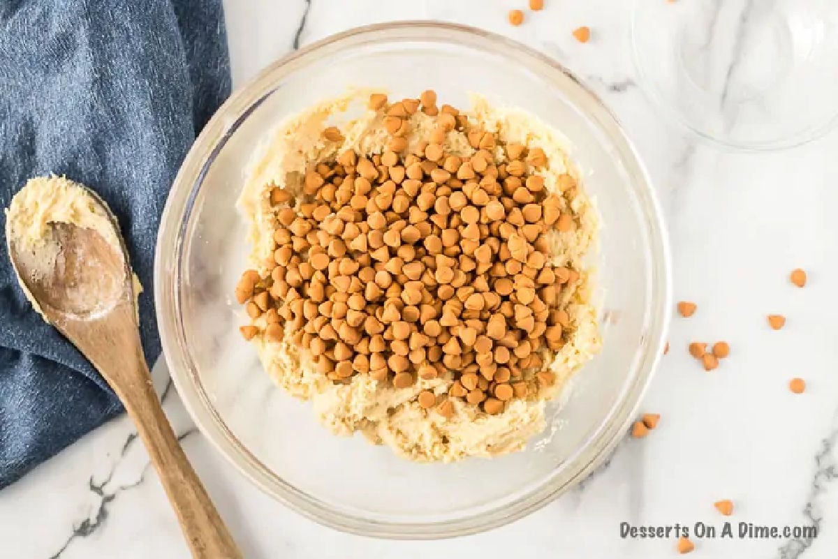 Mixing in the butterscotch chips into the cookie batter mixture