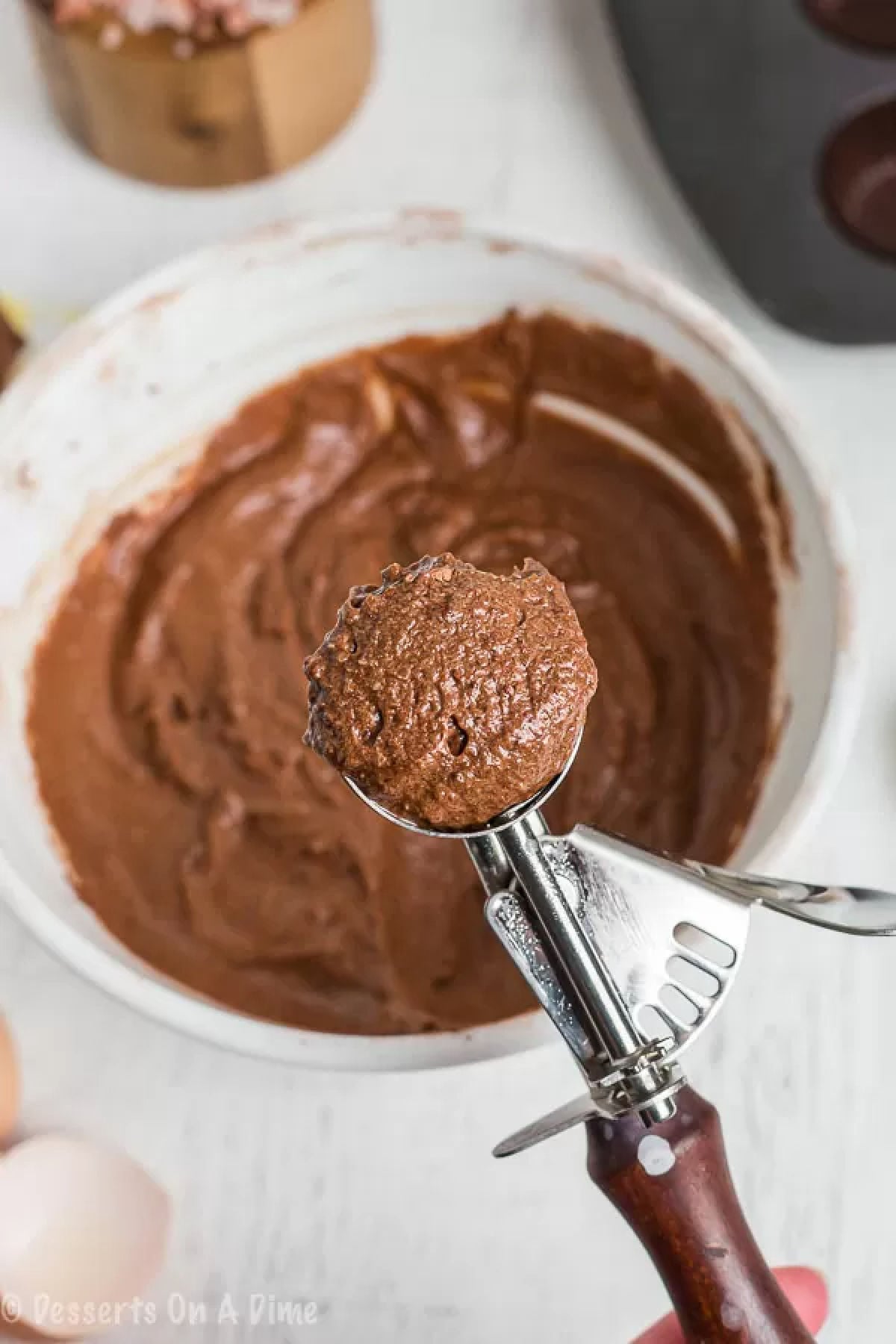 Chocolate batter in a cookie scoop. 