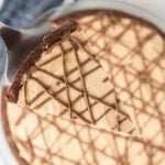 A slice of chocolate peanut butter pie with a fork lifting it up.