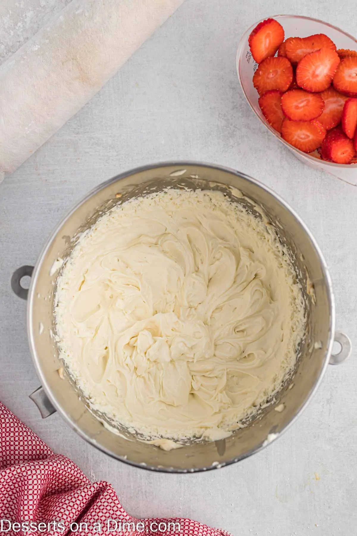 Whipping cream added to mixture in bowl.