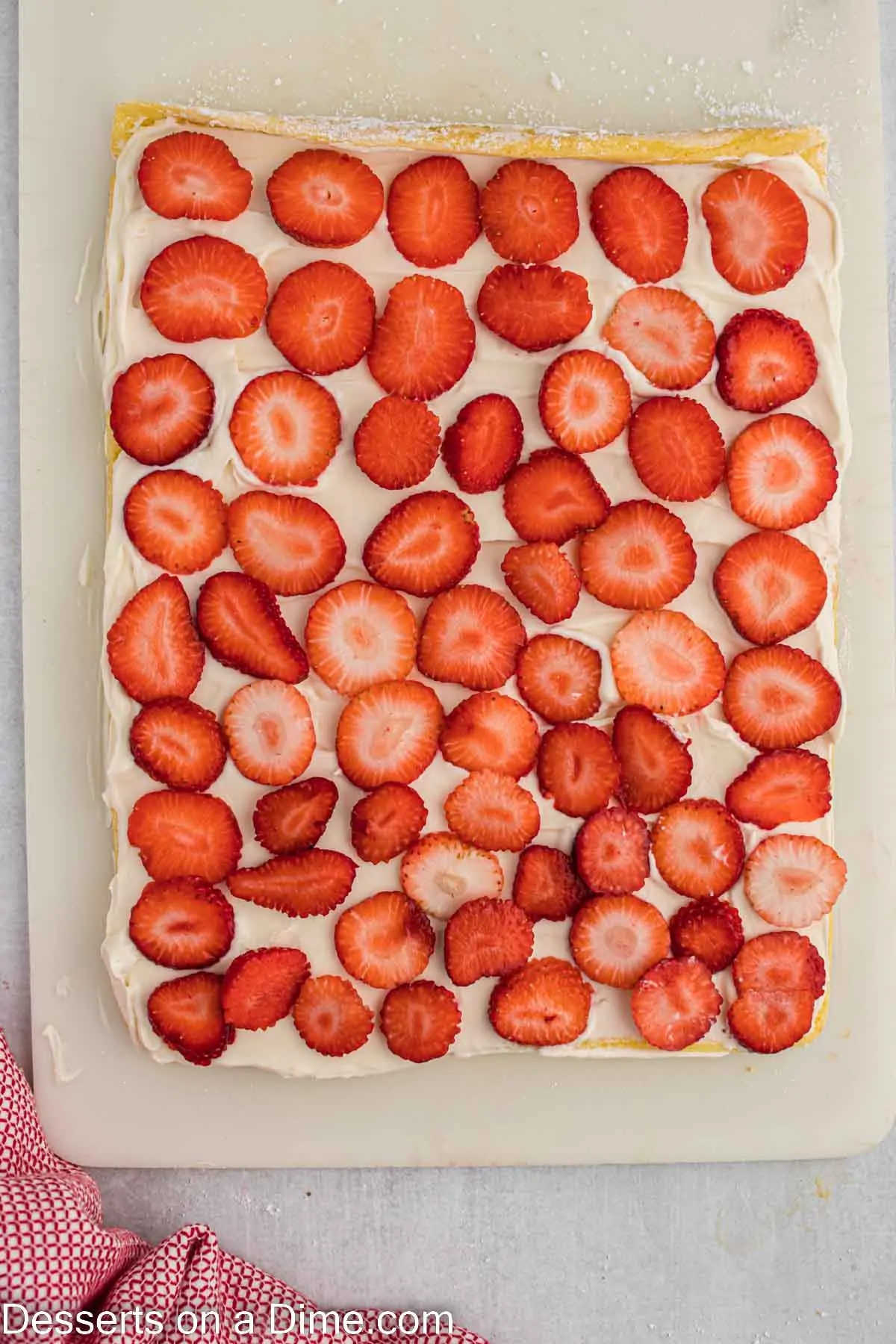Strawberries layered on cake.