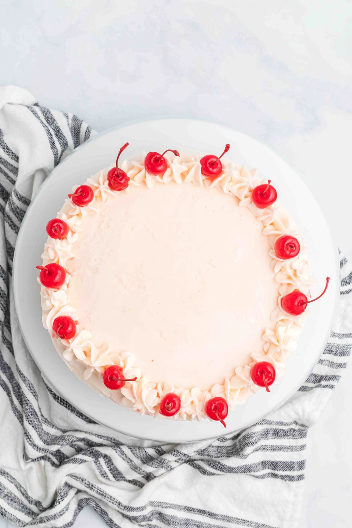 Cherries added to the top of the cake. 