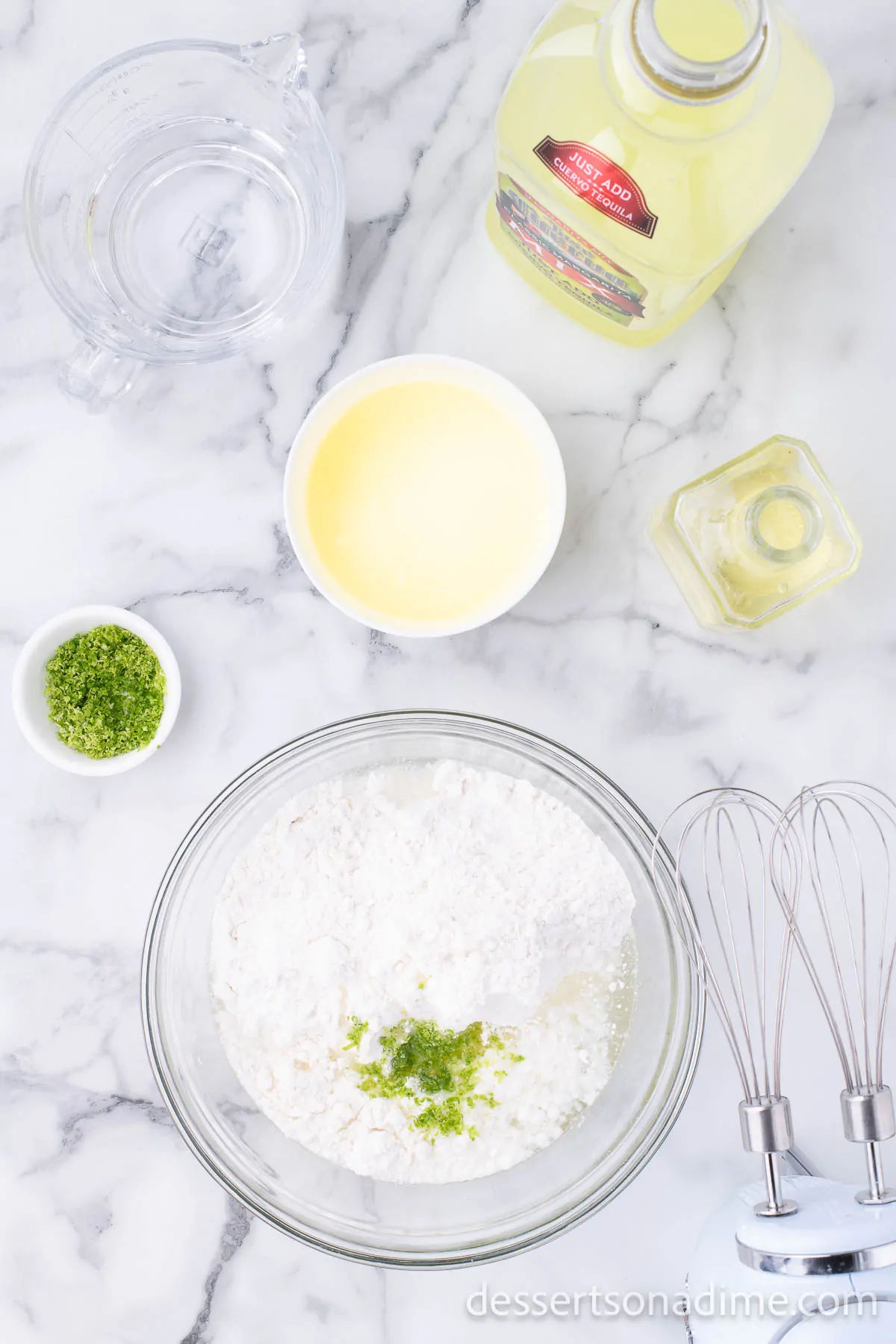 Mixing bowl with powdered sugar and lime.
