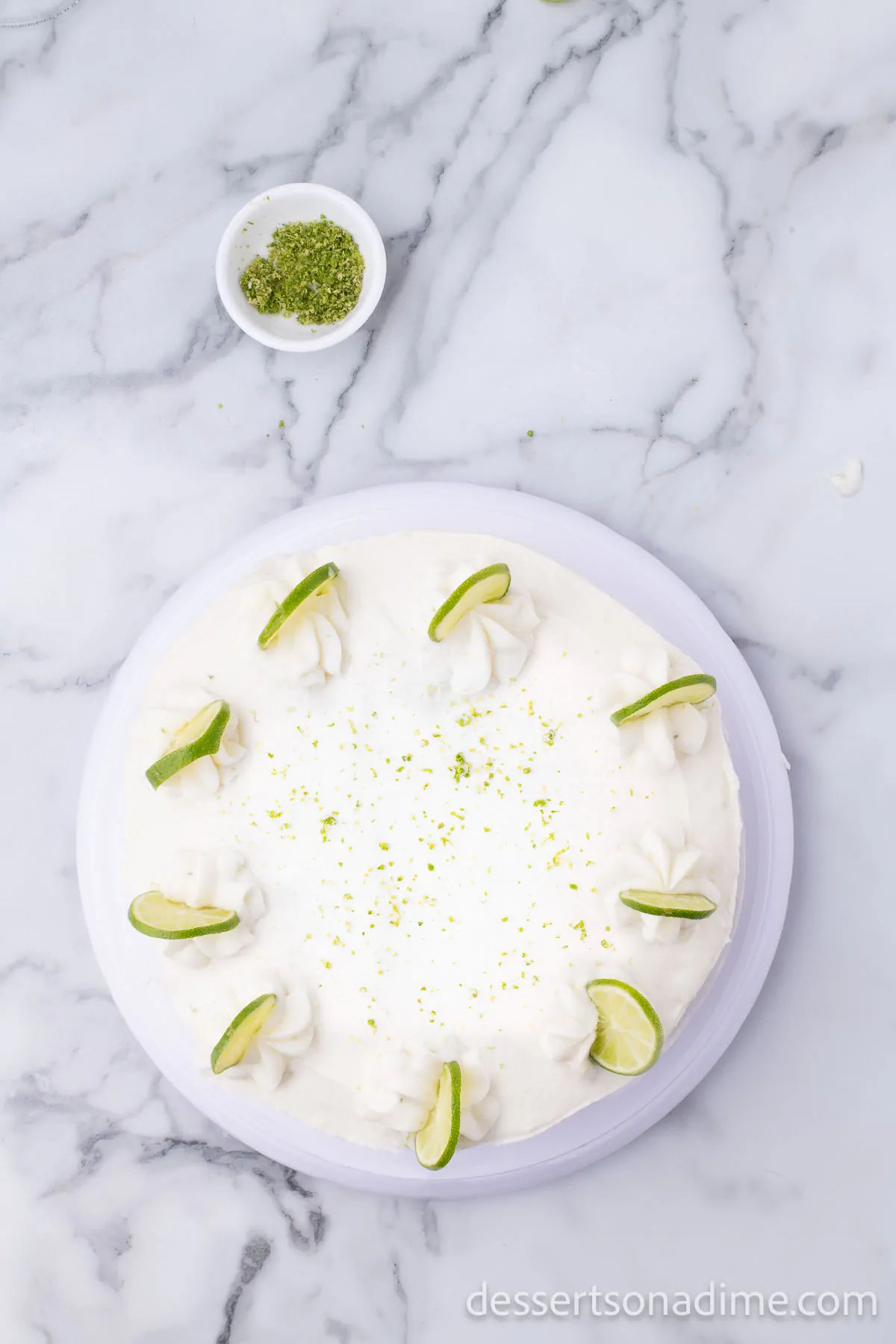 Lime slices and zest on top of cake.