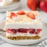 Strawberry Delight cut into squares and served on a white plate.