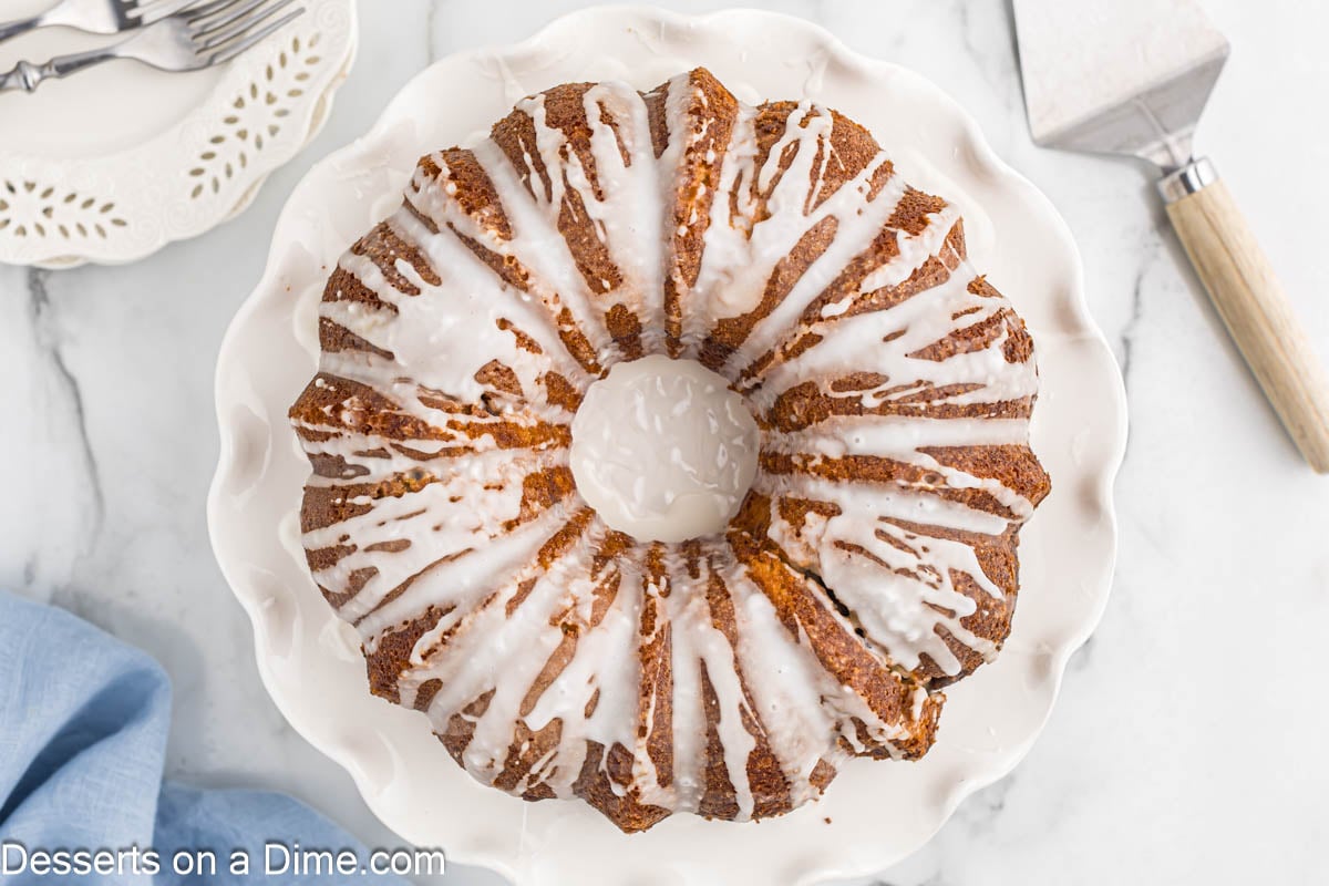 Sock it to me cake with glaze on a white platter.