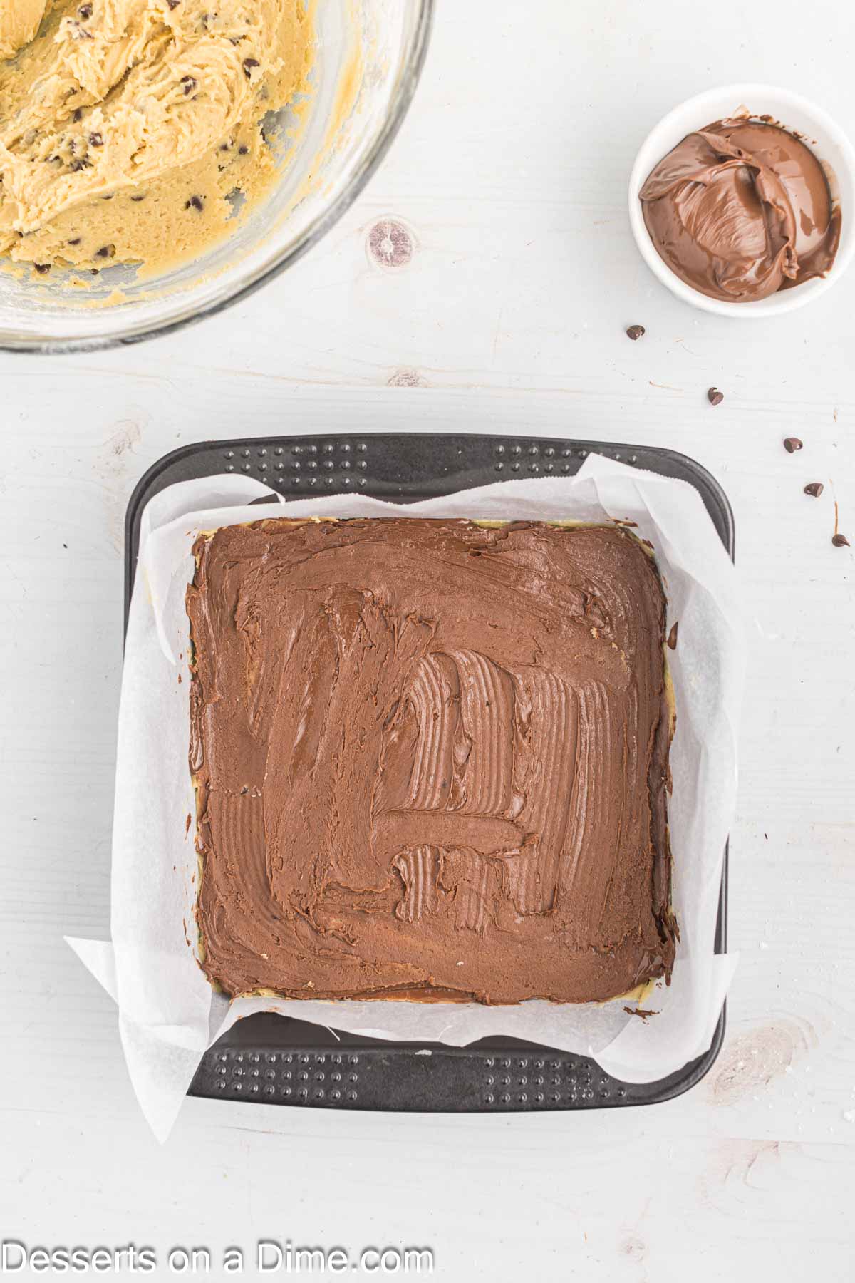 Chocolate spread on top of cookie dough. 