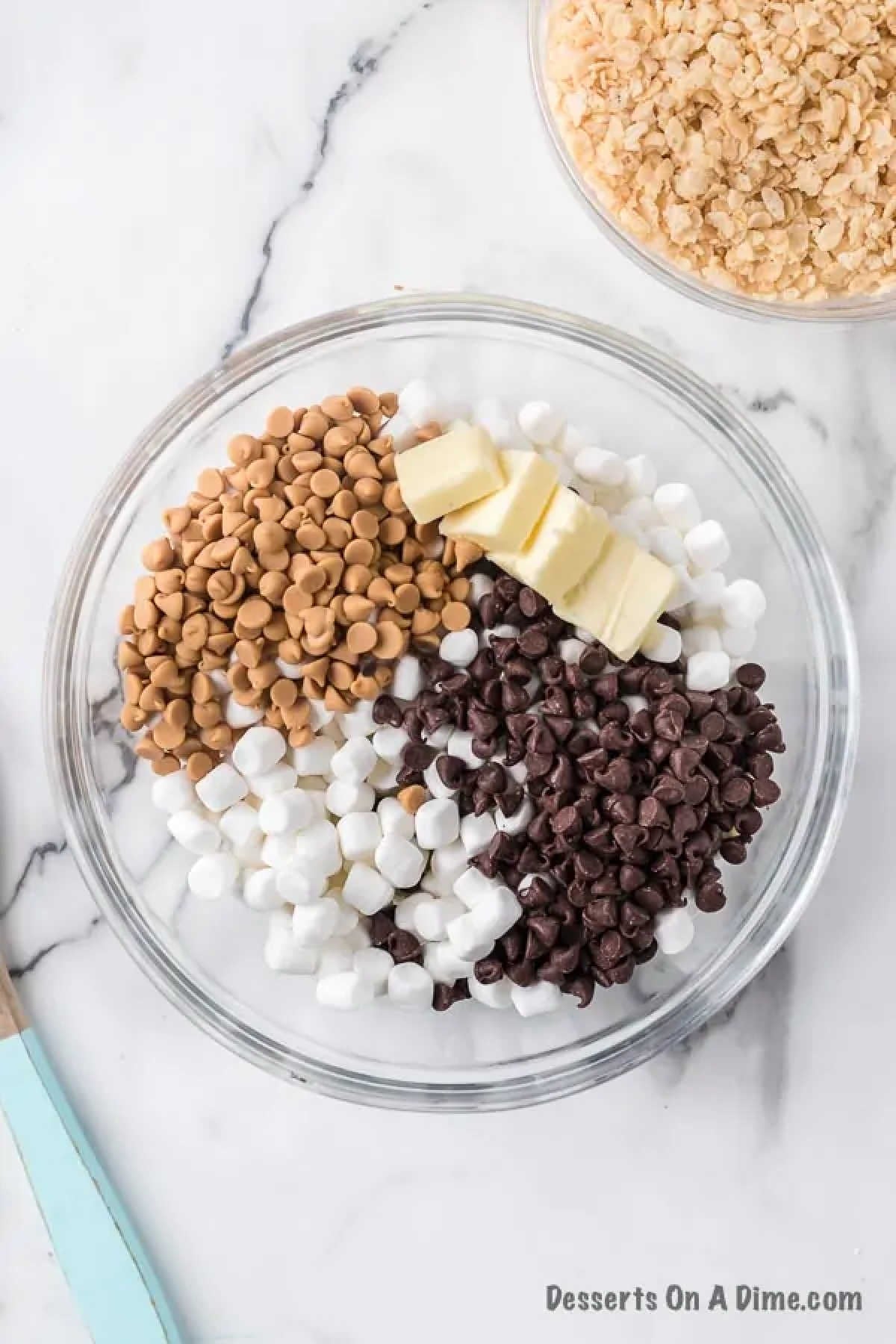 Mixing bowl with butter, chocolate chips, caramel and marshmallows.