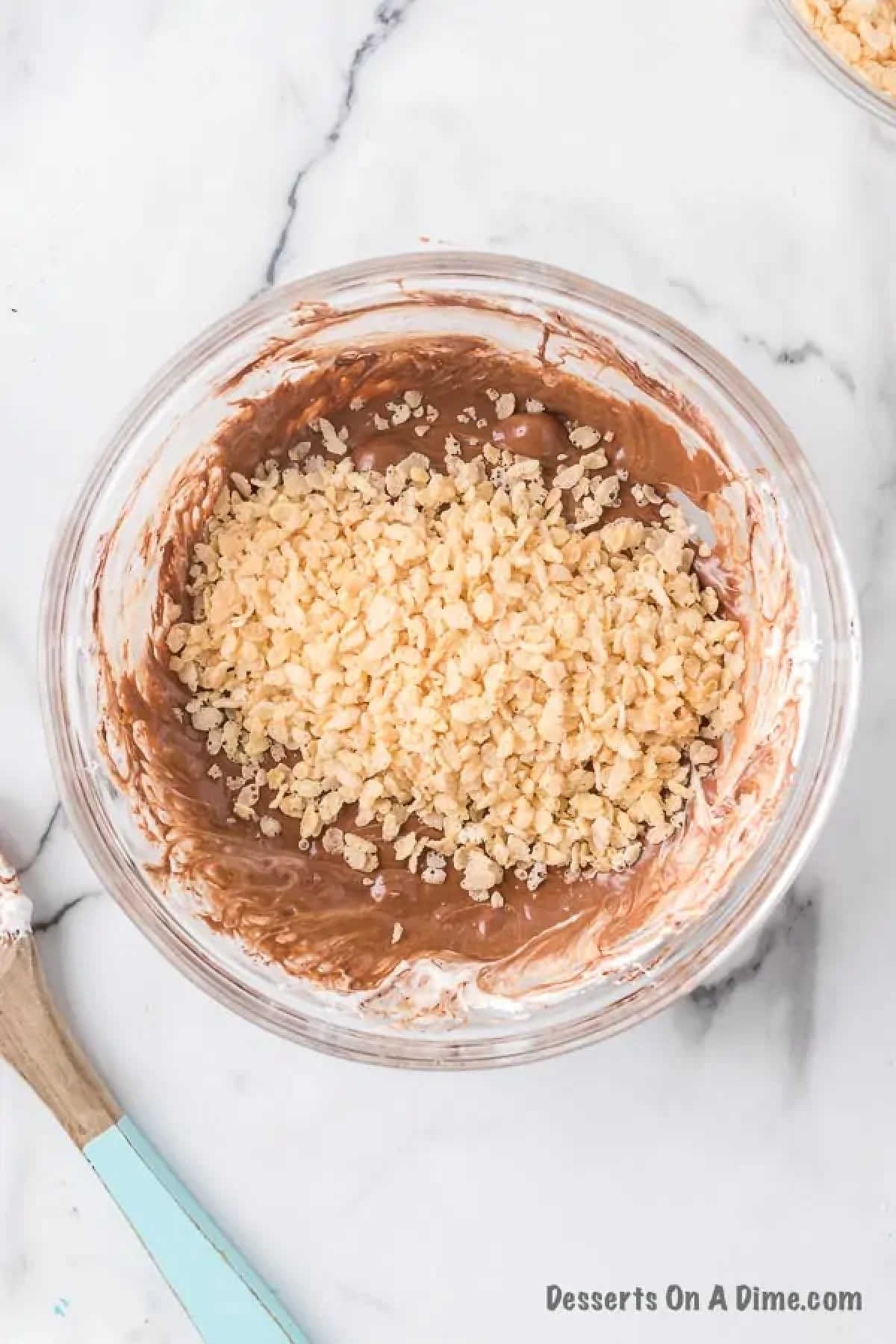 Cereal mixed into melted mixture. 