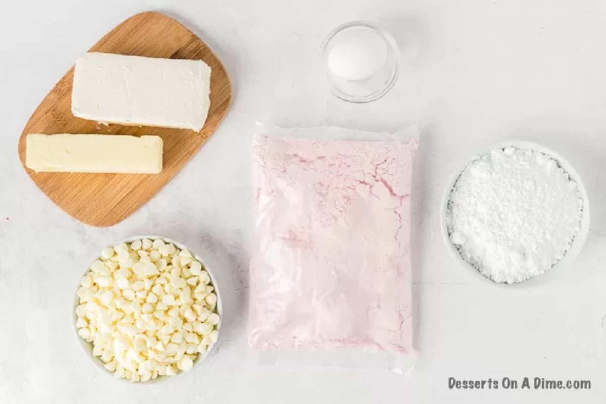 Ingredients needed for strawberry cheesecake cookies - butter, egg, white chocolate chips, strawberry cake mix, powdered sugar. cream cheese. 