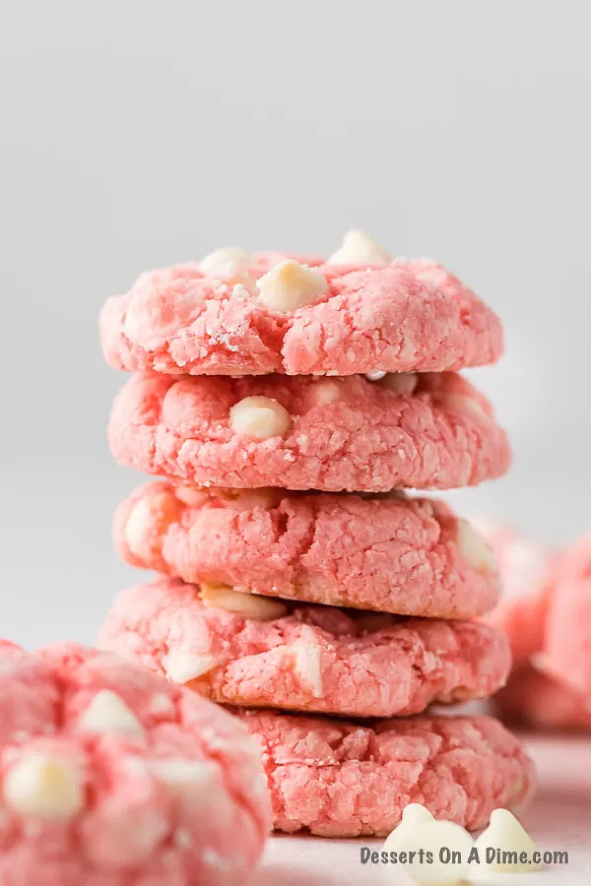 Close up image of strawberry cheesecake cookies stacked. 