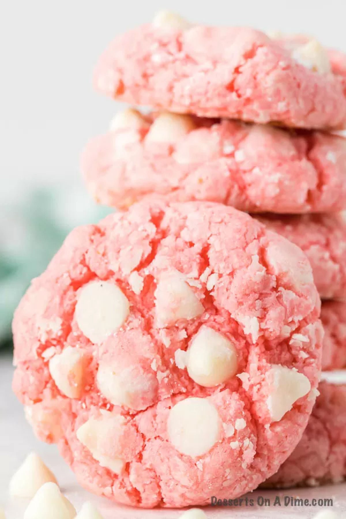 Close up image of strawberry cheesecake cookies stacked. 