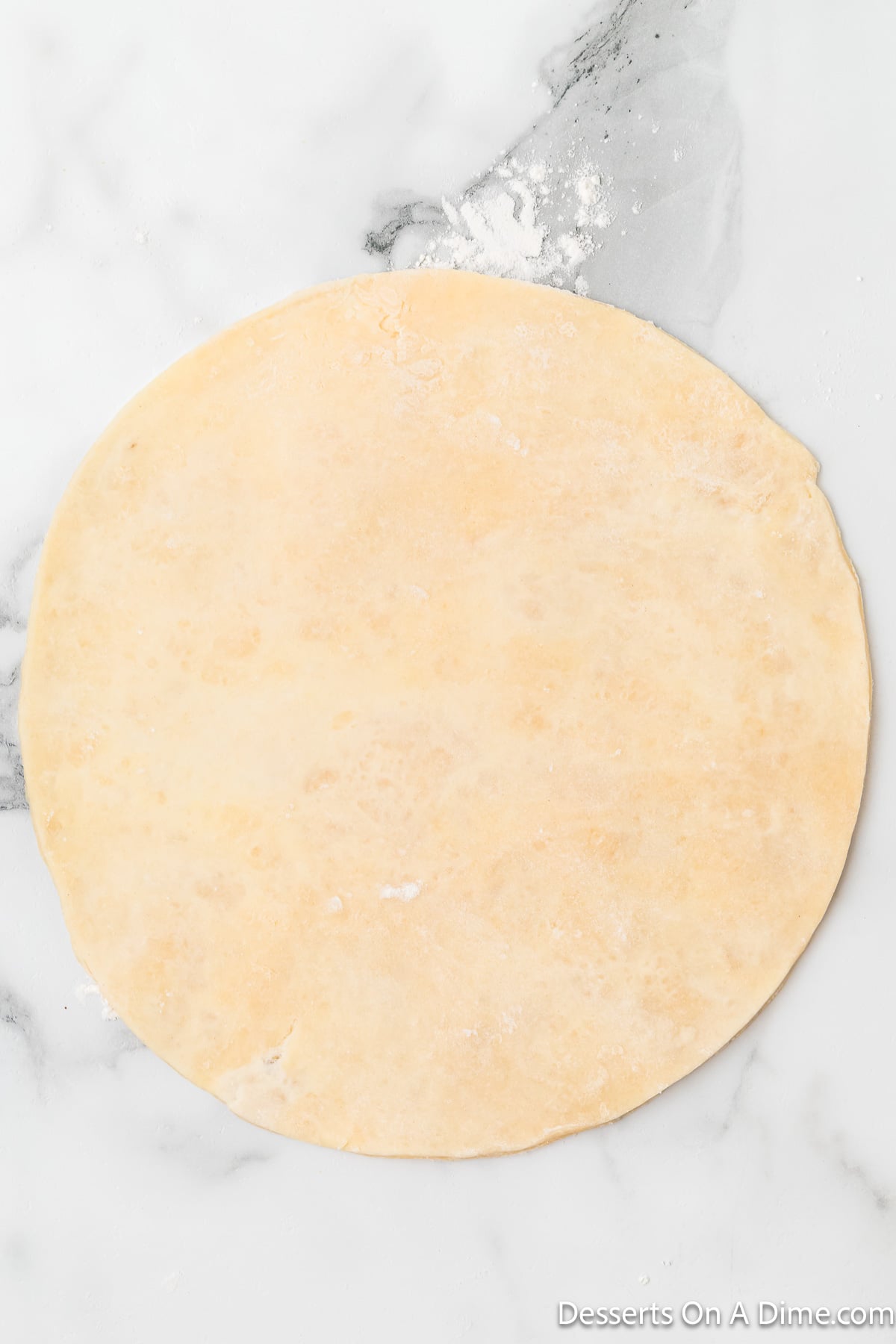 Dough rolled out into circle. 