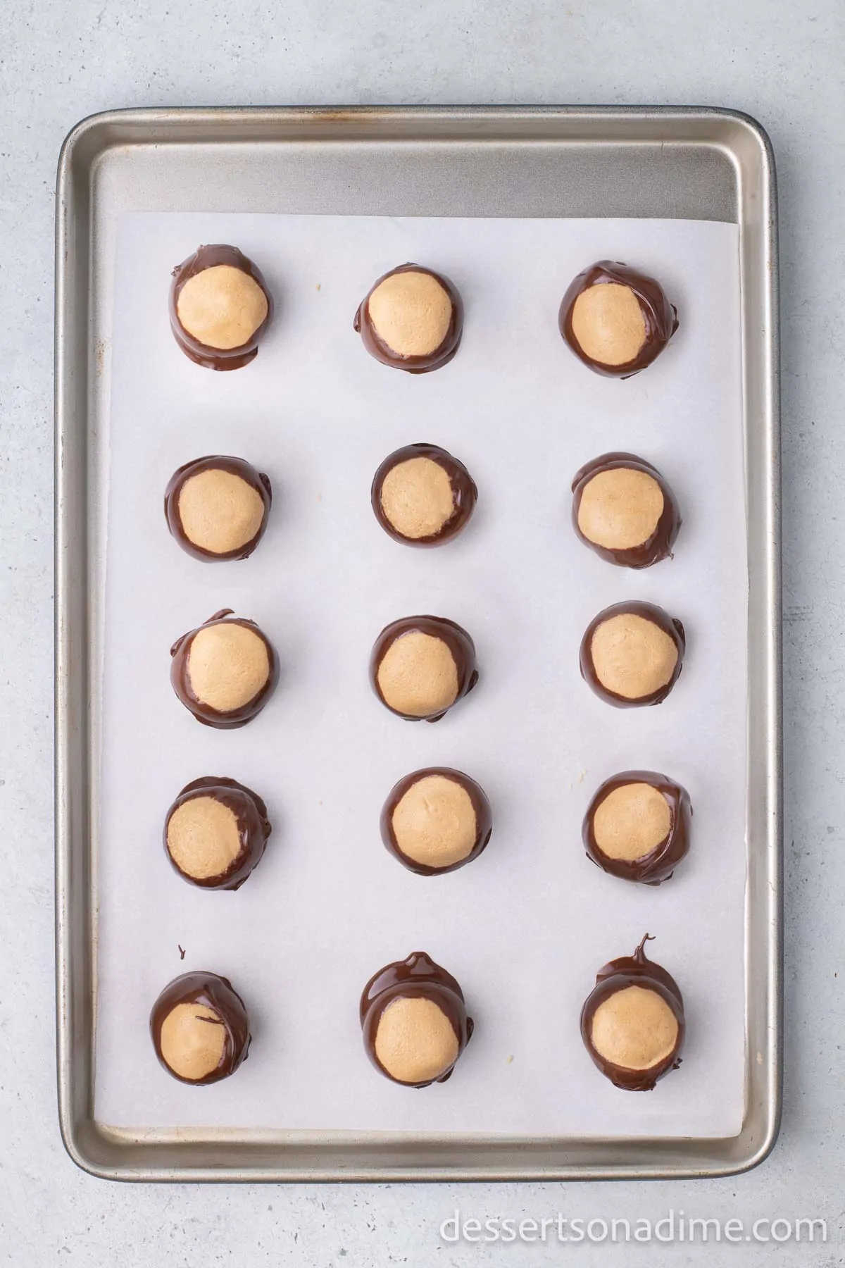 Peanut Butter Balls on baking sheet lined with wax paper.