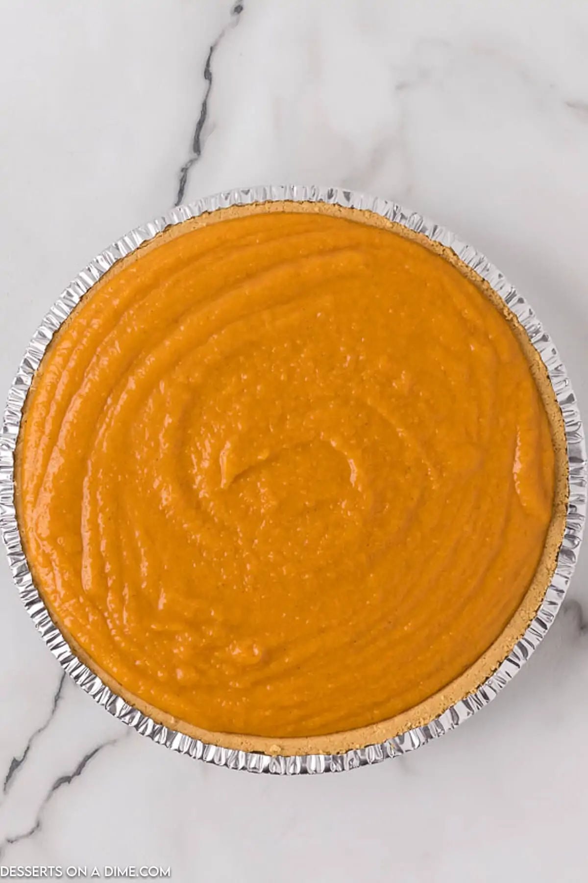 Pie filling poured into pie crust. 