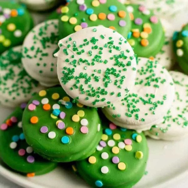 St. Patrick's Day Chocolate Covered Oreo cookies stacked together on a platter.