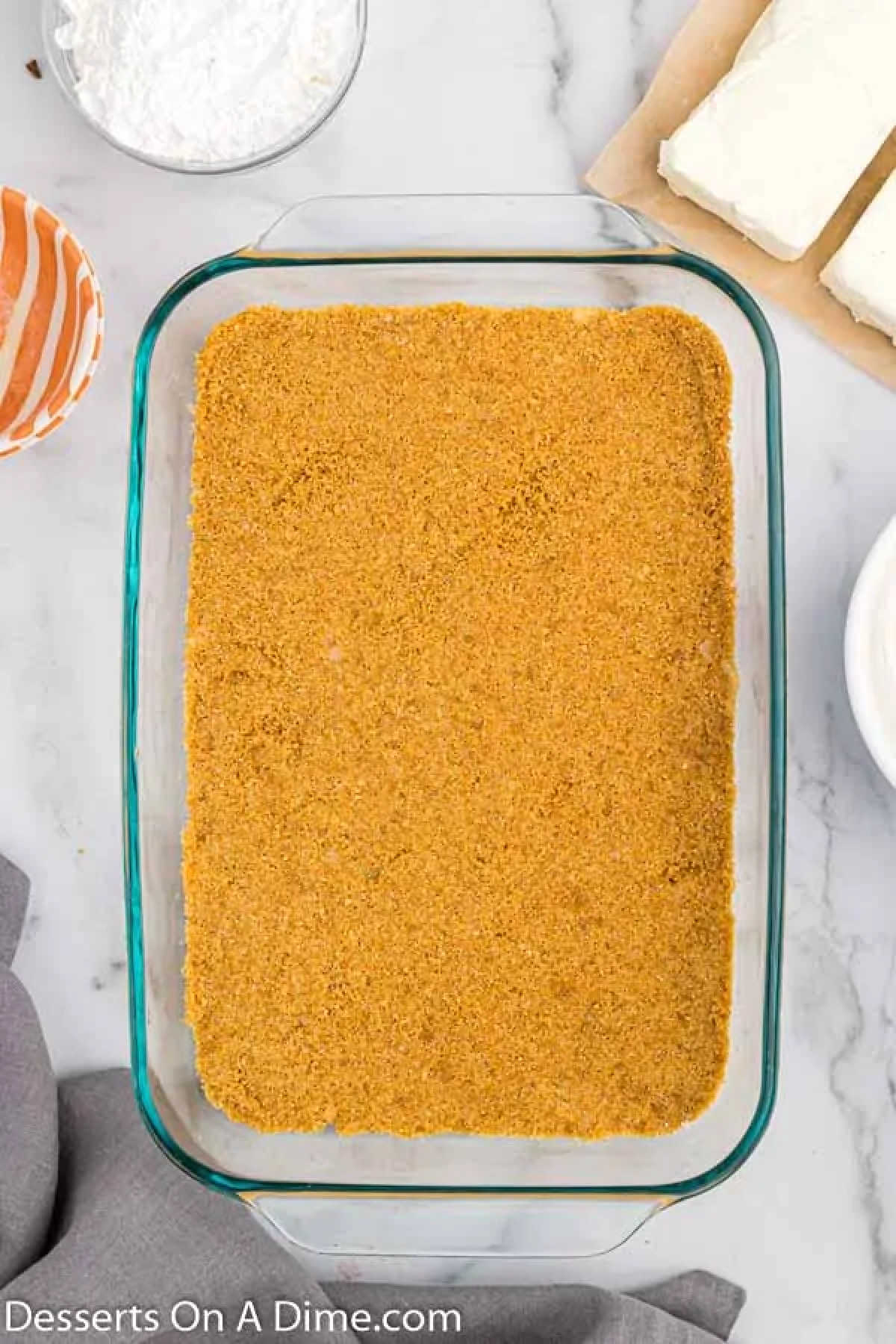 Crumbs pressed into a baking dish.